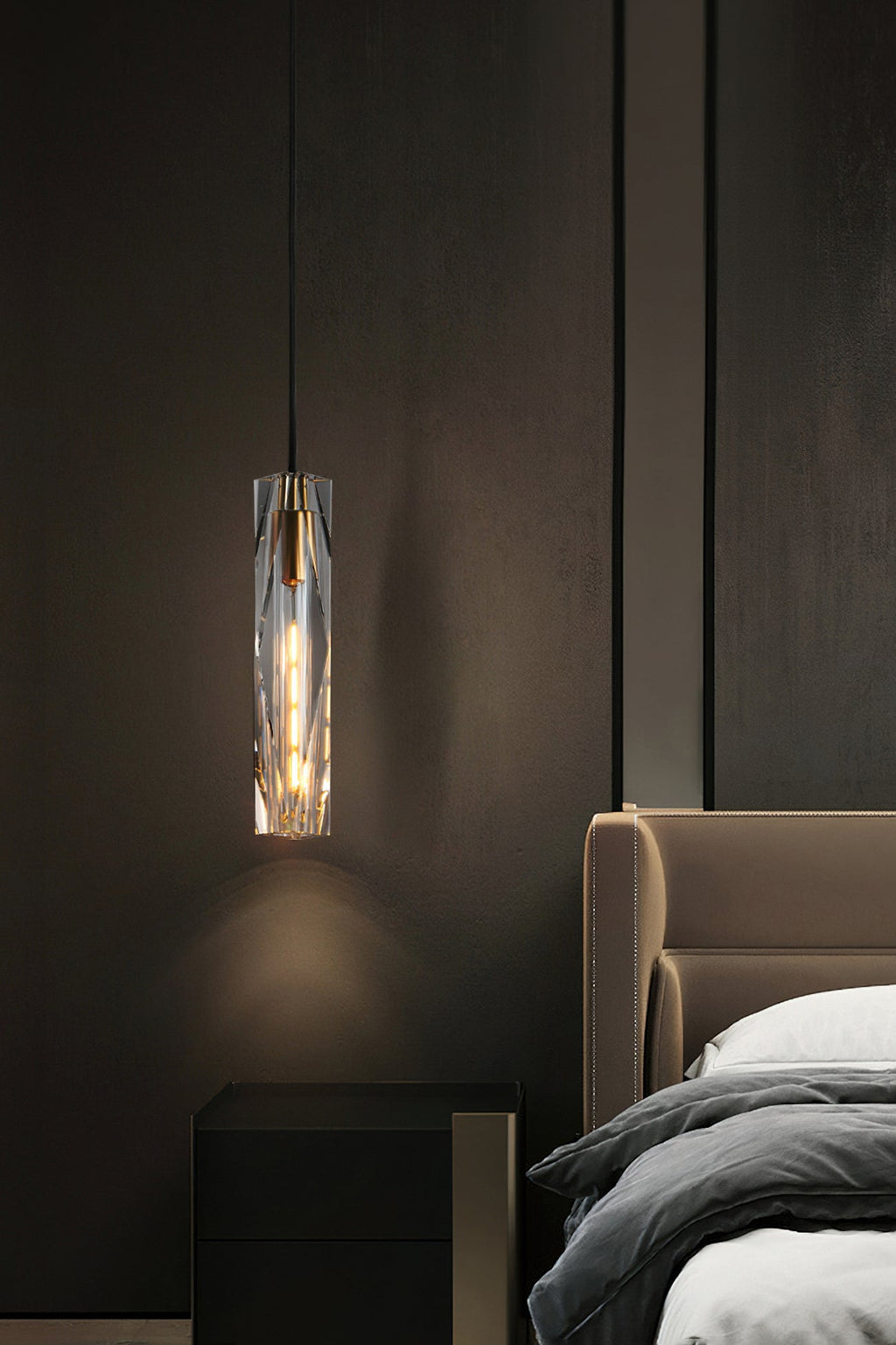 Clérachic crystal pendant hung beside a tan leather headboard and a black bedside cabinet, in a dim bedroom.