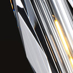 Close view of the cut facets of the crystal shade on this Clérachic pendant, with the filament bulb glowing behind them.