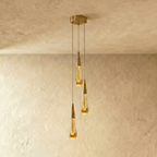 Clérachic crystal drop pendant light in a three-piece round cluster, staggered amber teardrops from one brass ceiling plate.