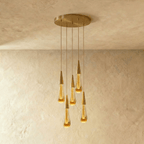 Clérachic crystal drop pendant light as a five-piece round cluster, amber glass teardrops cascading from a brass plate.