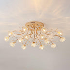 Clérachic gold ceiling light with glass flower shades and crystal drops, glowing warm with a spray of light on the ceiling above.
