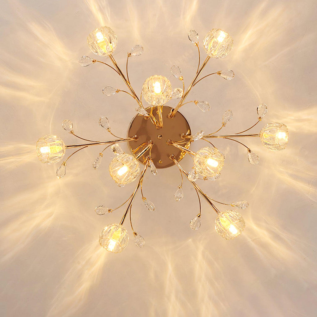 View from directly below of a gold Clérachic ceiling light, with glass flower shades on slim branches around a round canopy.