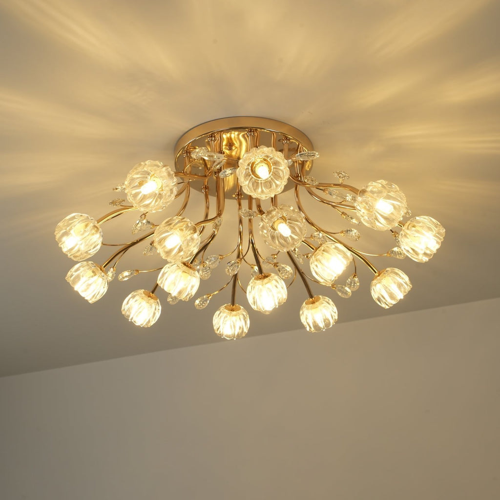 Lit gold ceiling light from Clérachic with glass flower shades, glowing warm with light patterns spread over the ceiling.