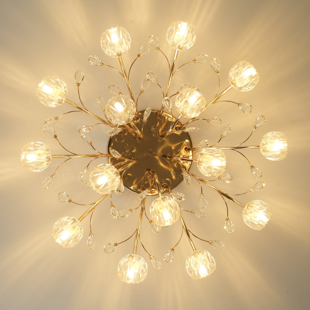 Underside view of a lit gold Clérachic ceiling light, with glass flower shades on slim branches around a round gold canopy.