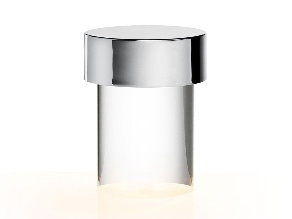 Close view of this Clérachic lamp on white, with a polished chrome cap over a clear smooth glass body.