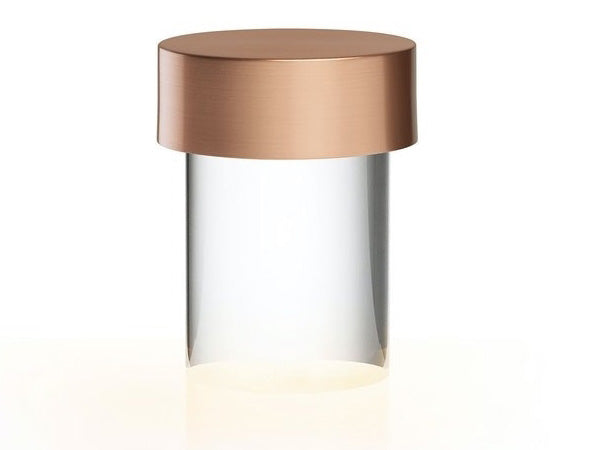 Close view of this Clérachic lamp on white, with a brushed rose gold cap over a clear smooth glass body.