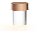 Close view of this Clérachic lamp on white, with a brushed rose gold cap over a clear smooth glass body.