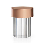 A fluted-glass Clérachic lamp with a rose gold cap on white, with vertical ribs running the full height of the glass.