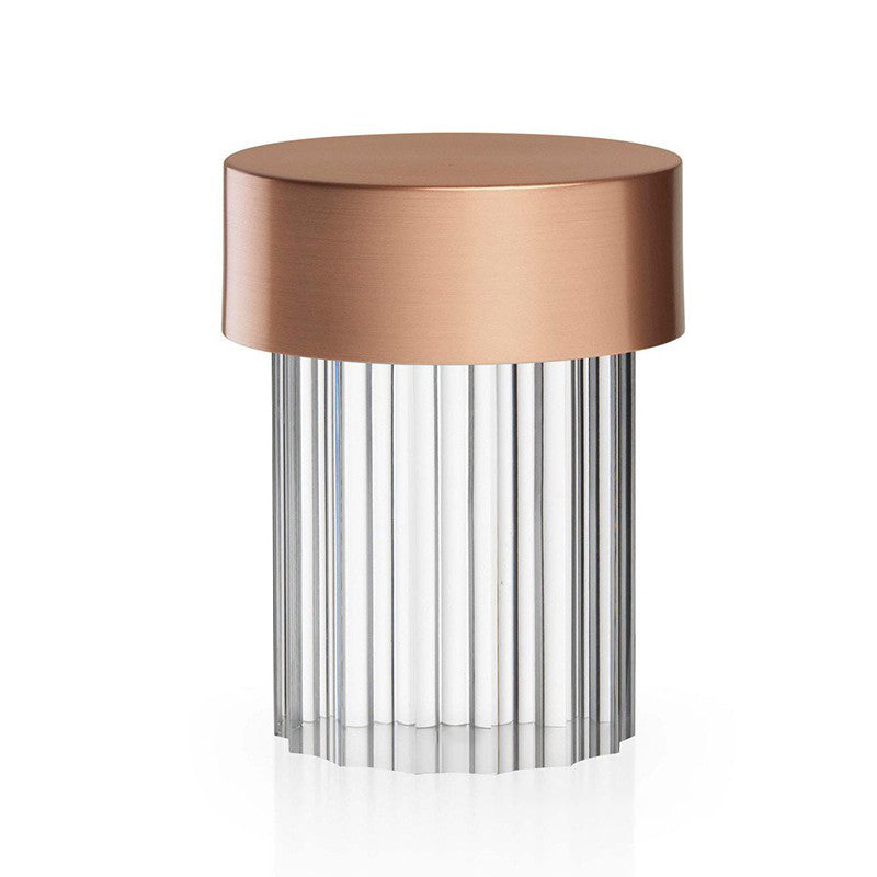A fluted-glass Clérachic lamp with a rose gold cap on white, with vertical ribs running the full height of the glass.