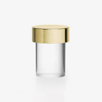 This Clérachic cordless table lamp on a plain white backdrop, with a polished gold cap over a clear smooth glass body.