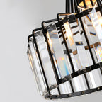 Detail of the black metal frame, riveted fixings and clear glass prisms on this Clérachic drum pendant, seen from below.