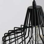 Close view of the black wire cage, cable gland and clear bulb of this Clérachic crystal drum pendant, against a soft grey wall.