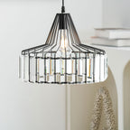 Close view of the black wire cage and clear prisms on this Clérachic pendant, with white books and a speckled ornament behind.