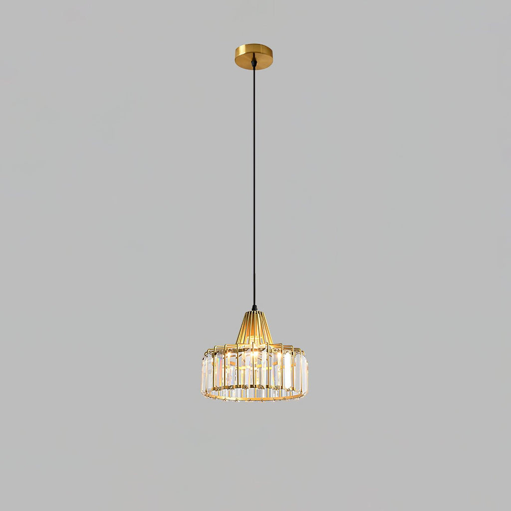 Gold crystal drum pendant from Clérachic on a gold ceiling plate and long cable, against a flat grey backdrop.