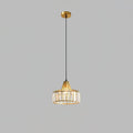 Gold crystal drum pendant from Clérachic on a gold ceiling plate and long cable, against a flat grey backdrop.