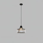 Black crystal drum pendant from Clérachic on a black ceiling plate and long cable, against a flat grey backdrop.