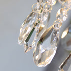 Detail of faceted teardrop crystals on this Clérachic pendant light, each hung from fine gold-coloured rings.