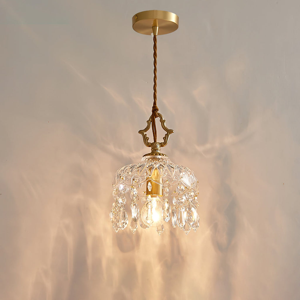 Lit against a softly rippled wall, this Clérachic pendant light hangs from a round gold ceiling plate on a twisted cord.