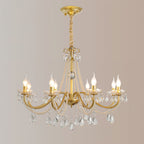 A Clérachic gold chandelier on a gold ceiling canopy and a wrapped chain, with candle bulbs lit against a blush-grey backdrop.