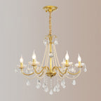 A Clérachic gold chandelier with a gold ceiling canopy and a wrapped chain, its candle bulbs lit, against a soft rose-grey backdrop.