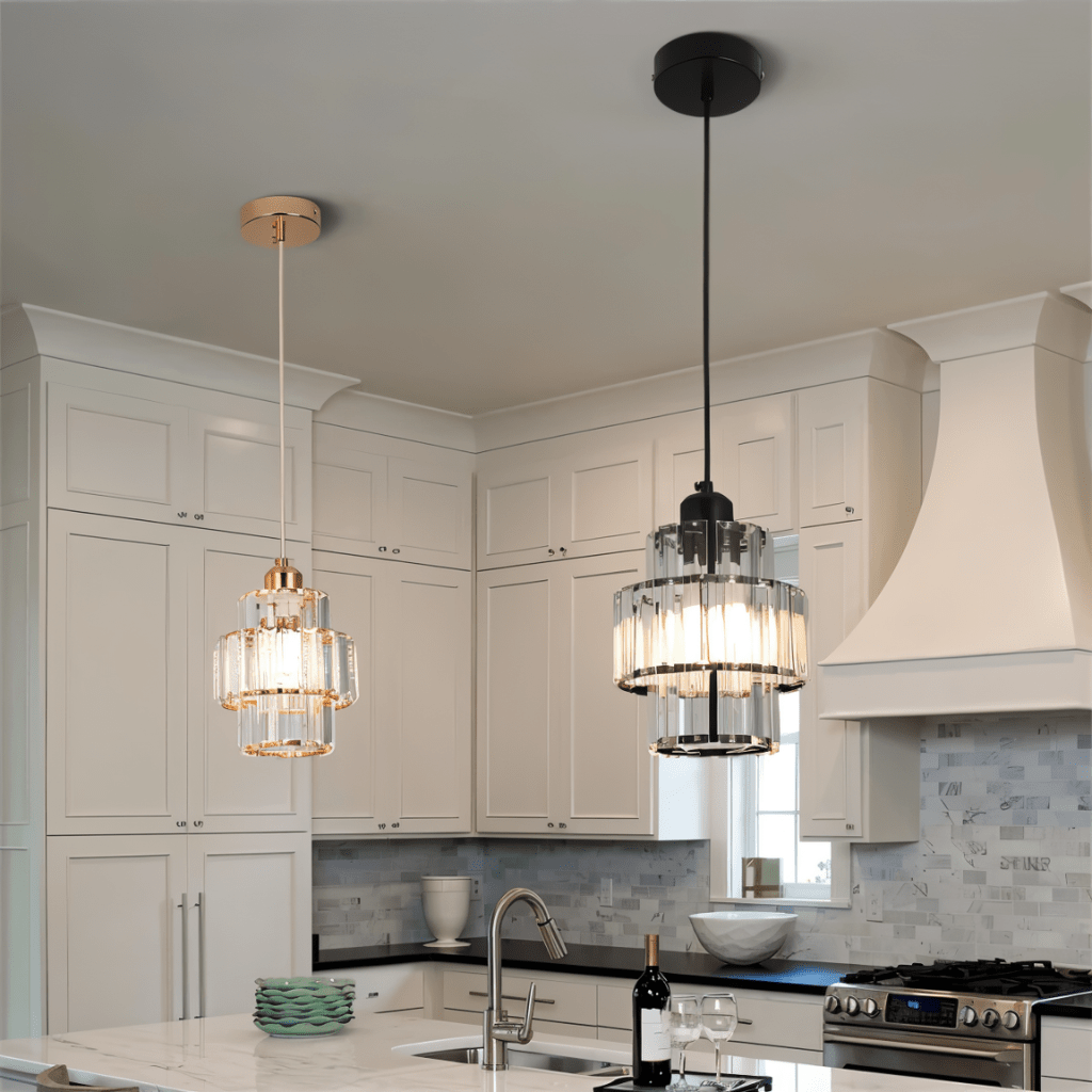 Clérachic crystal pendants in gold and black frames side by side above a marble kitchen island.