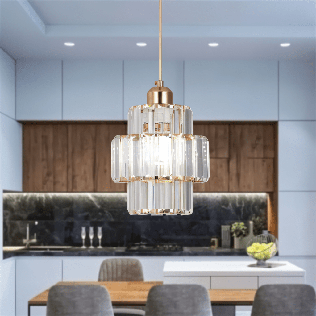 Clérachic gold-framed crystal pendant lit above a dining table, in front of pale blue cabinets and oak panelling.