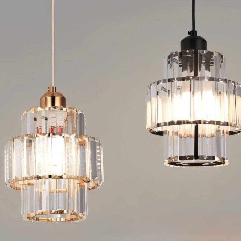 Clérachic crystal pendants in gold and black finishes shown close together, each lit with three glass tiers.