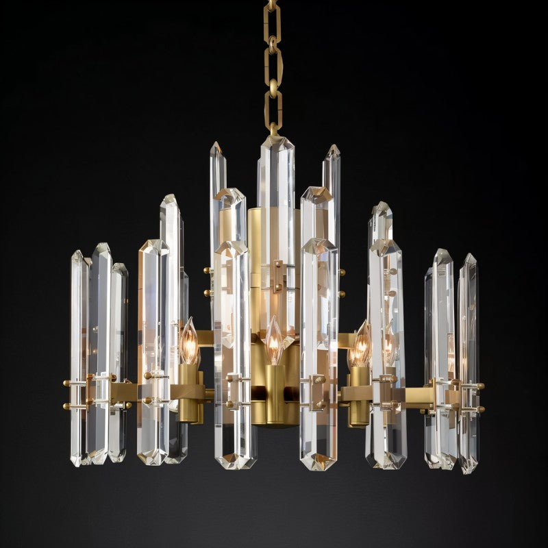 Clérachic round chandelier of faceted clear crystal rods on a brass frame, lit by candle-style bulbs against a black ground.