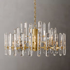 Clérachic wider two-tier chandelier of clear crystal rods on a brass frame, with candle-style bulbs on a grey ground.