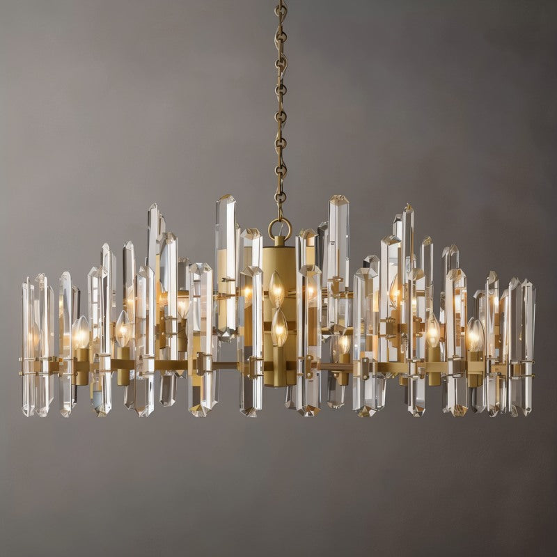 Clérachic widest round chandelier of clear crystal rods on a brass frame, with many candle bulbs, on a grey ground.
