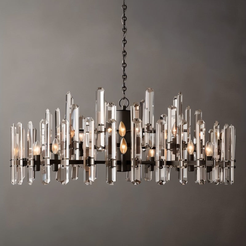 Clérachic widest round chandelier of clear crystal rods on a matte black frame, with many candle bulbs, on a grey ground.