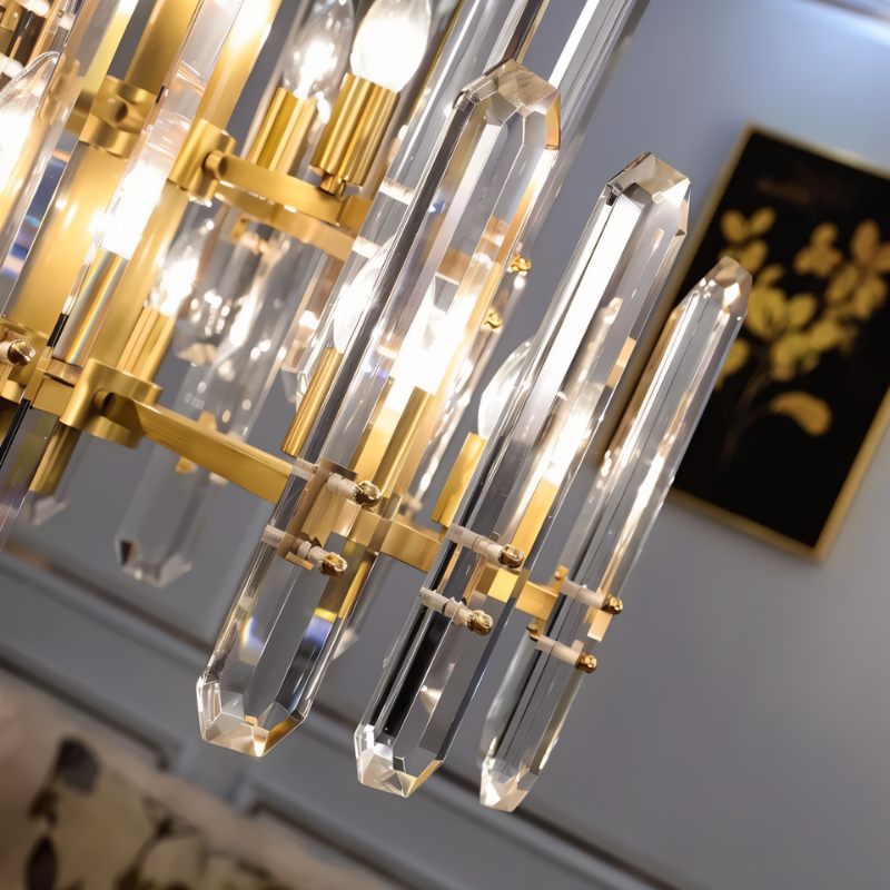 Clérachic close-up of faceted crystal rods, brass clamps and glowing candle bulbs, with a gold-leaf painting behind.
