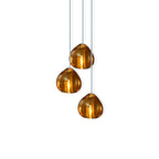 Close-cropped view of three amber glass heads on this Clérachic pendant, each lit from inside and hung on a pale cord.