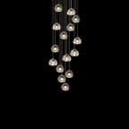 Fifteen or so clear glass heads on this Clérachic pendant hang in a loose column against black.