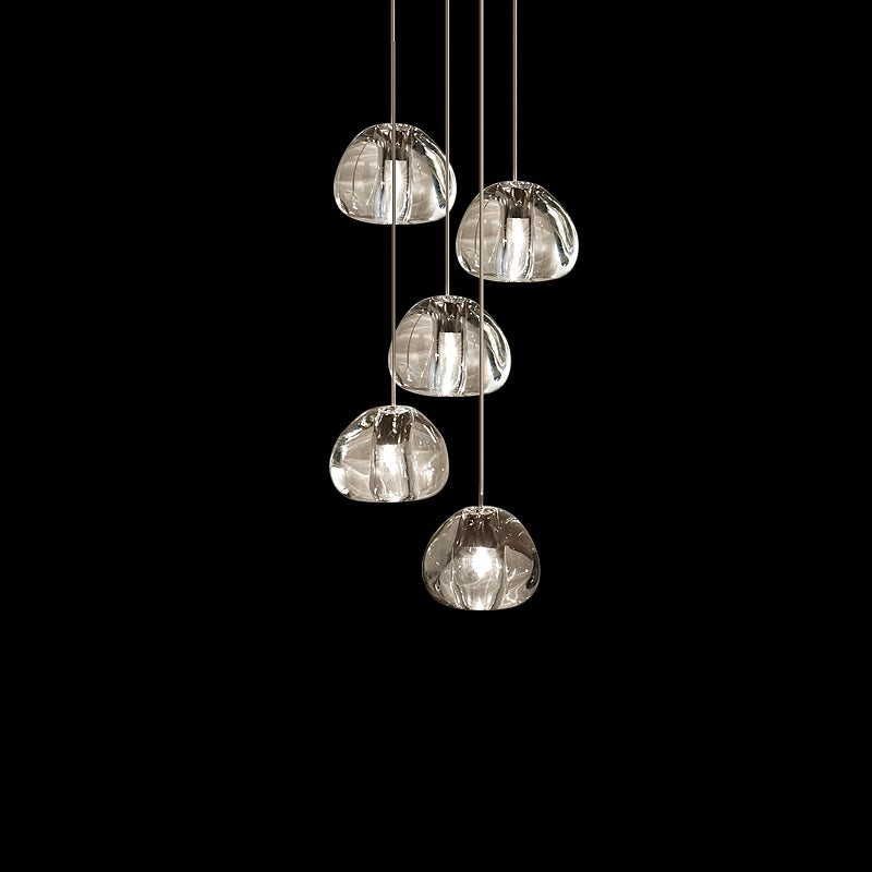 Five larger clear glass heads on this Clérachic pendant hang on pale cords against black.