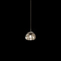 A single clear glass head on this Clérachic pendant hangs on a slim cord against a black background.