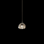 A single clear glass head on this Clérachic pendant hangs on a slim cord against a black background.