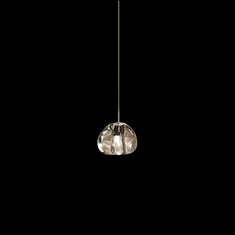 A single clear glass head on this Clérachic pendant hangs on a slim cord against a black background.