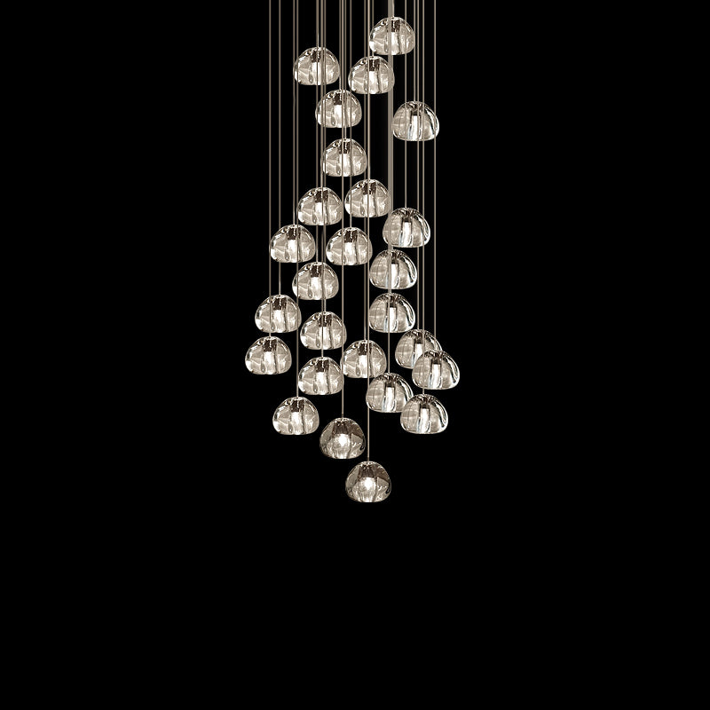 A tall cluster of clear glass heads on this Clérachic pendant hangs on thin cords against a black backdrop.