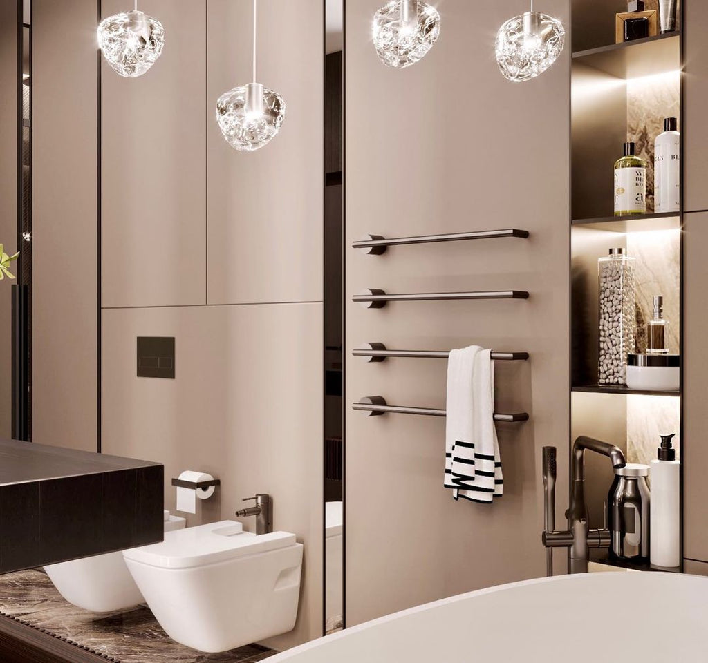In a beige bathroom with a heated towel rail, this Clérachic pendant's clear glass heads hang at the top of the frame.