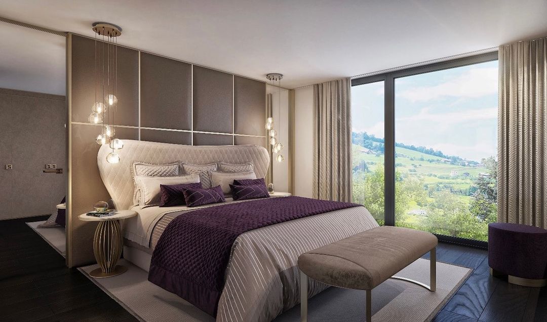 In a bedroom with purple bedding and a large window, this Clérachic pendant hangs by the bedside in a small group.
