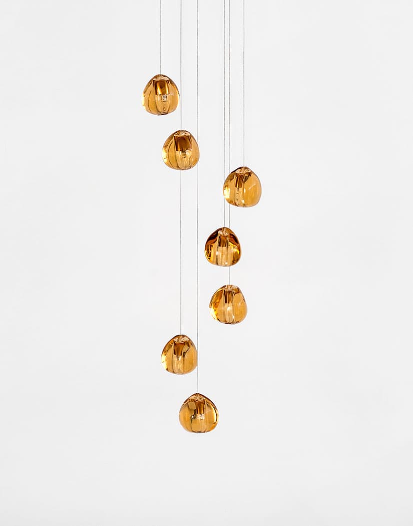 Seven amber glass heads of this Clérachic pendant hang in a loose cluster on a plain white background.