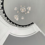 Looking straight up a spiral stairwell, this Clérachic pendant's clear glass heads fan out from a central canopy.