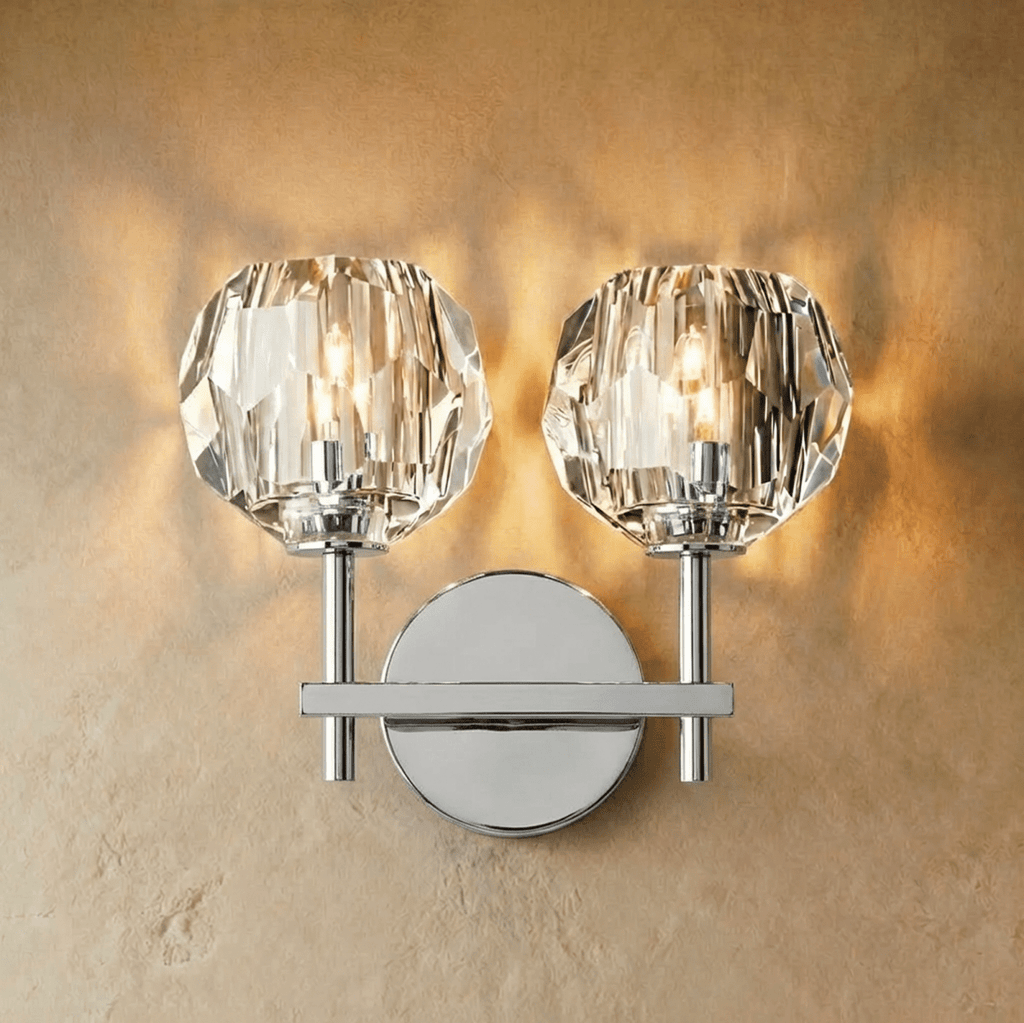 Clérachic two-head silver wall sconce, twin faceted crystal shades lit on a polished crossbar and round plate.