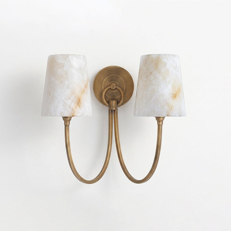 Two-light antique bronze sconce with veined alabaster shades and looping arms joined at a round backplate, from Clérachic.