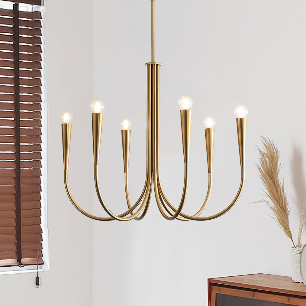 Close view of a Clérachic chandelier in a brass tone with conical bulb holders, beside wooden slatted blinds and dried grasses.