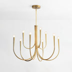 Brass-toned Clérachic chandelier with two tiers of curving arms, on a pale grey backdrop with a round ceiling plate.