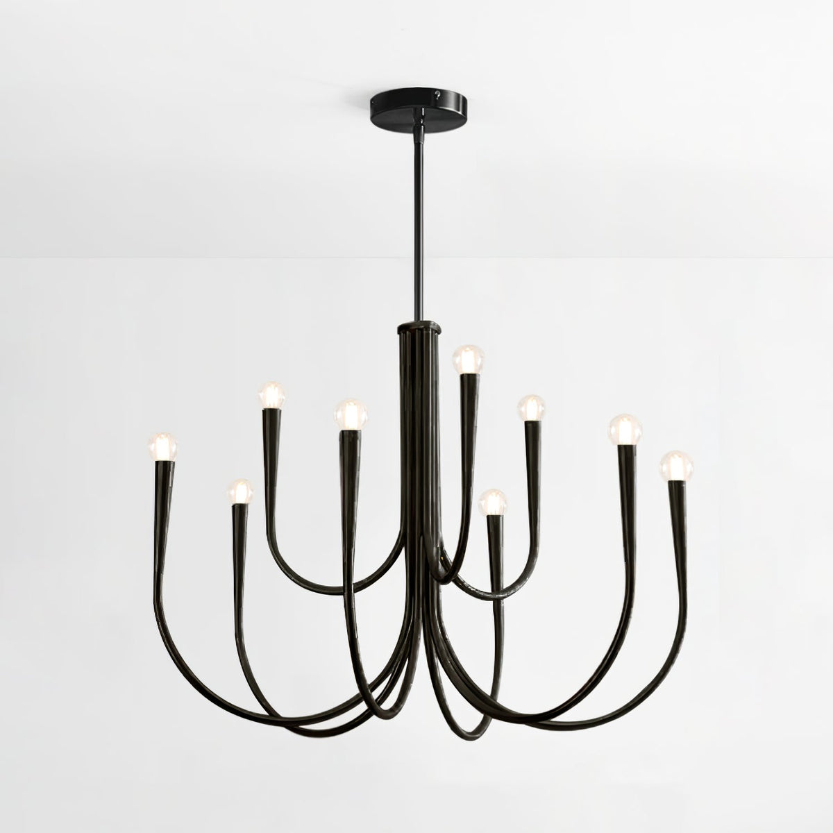 Black Clérachic chandelier with a slim black rod and plate, shown on a plain white backdrop with bare bulbs along looped arms.