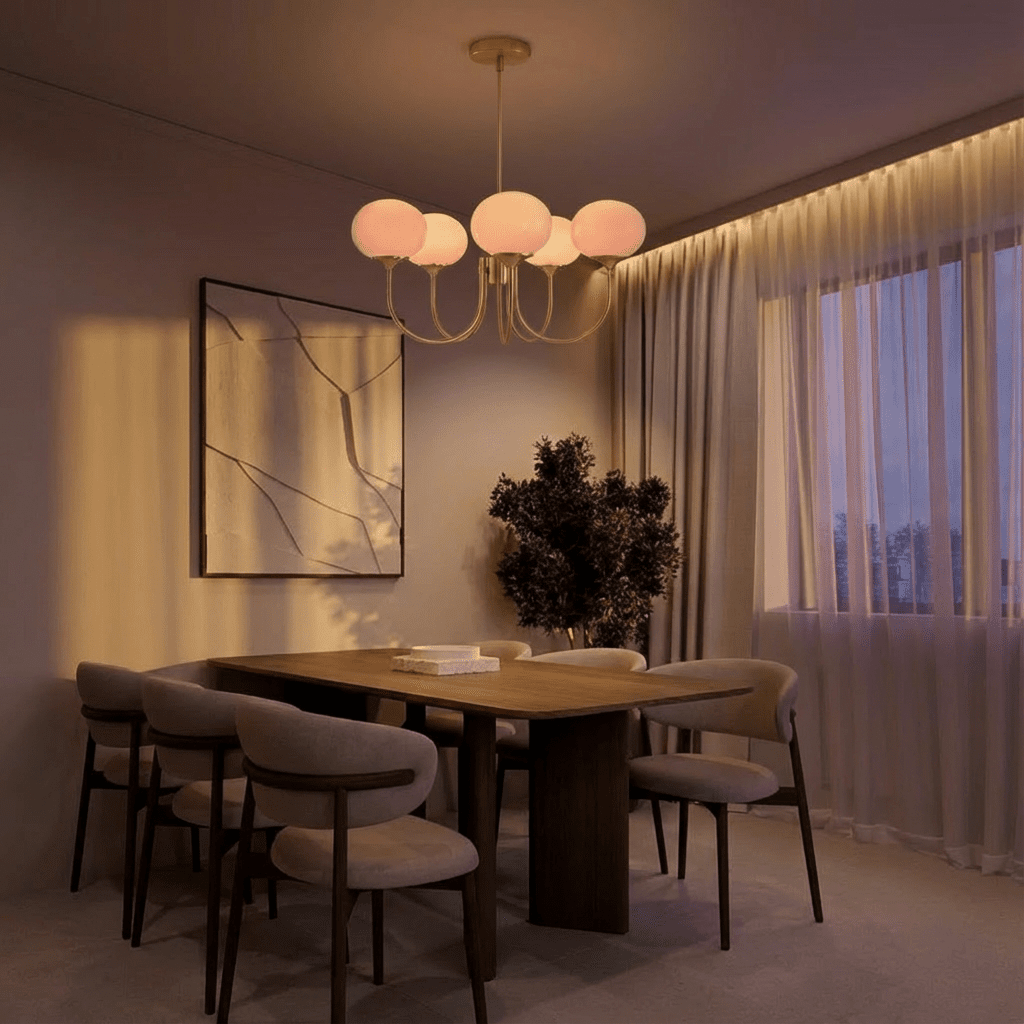 Clérachic five-light chandelier with pink-glowing oval glass shades over a dark dining table in a softly lit evening room.