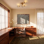 Clérachic gold ceiling light with four curved arms and glass shades above a walnut desk in a bright, sunlit study.